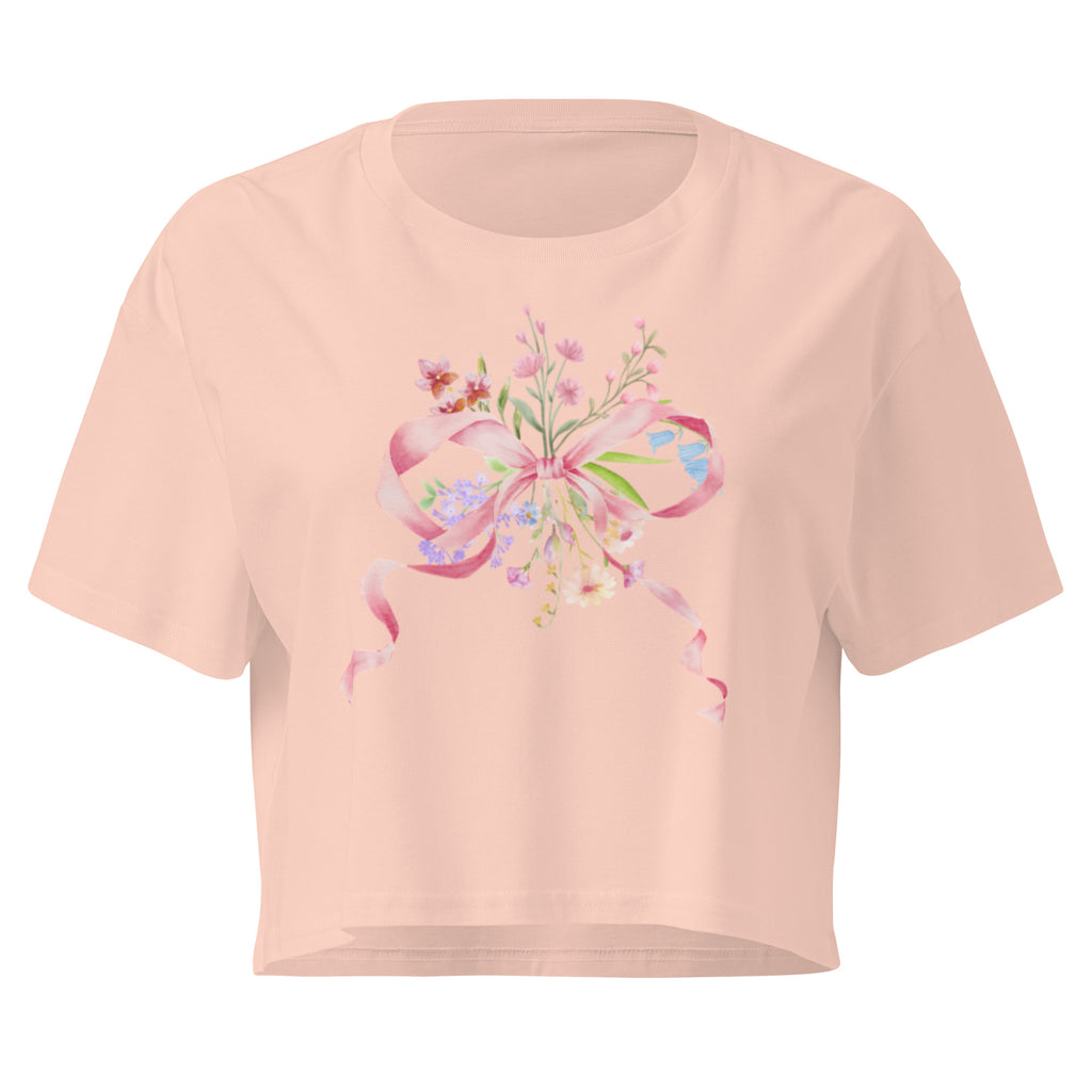 Pink crop top with floral and bow design on a white background